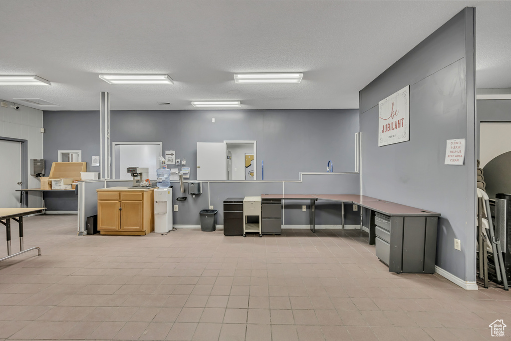 Misc room featuring light tile patterned floors and a textured ceiling