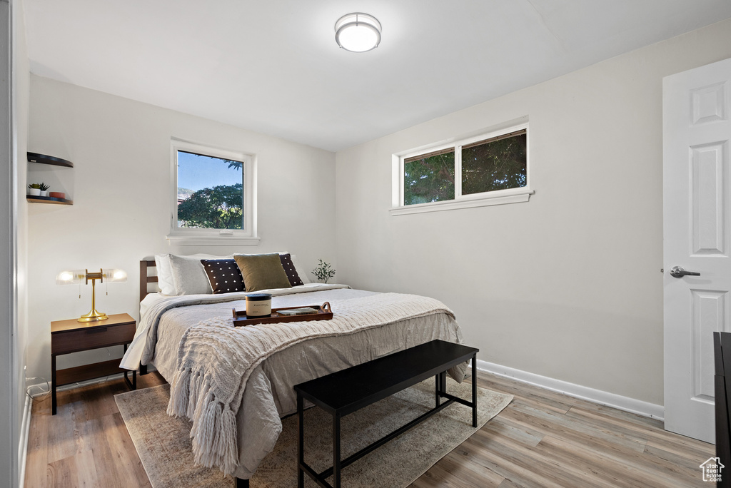 Bedroom with light wood-style floors and baseboards