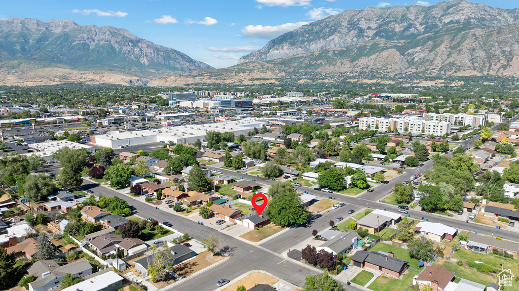 Aerial view of property and surrounding area with a mountainous background