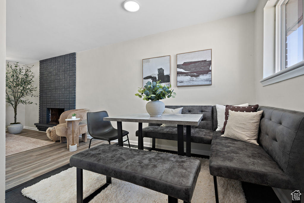 Dining room with a fireplace and wood finished floors