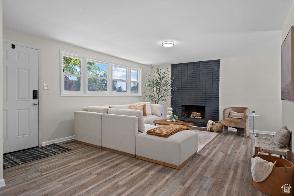 Living room with wood finished floors and a fireplace