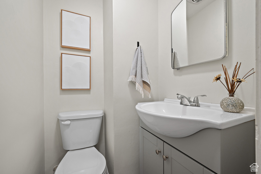 Half bath featuring vanity and toilet
