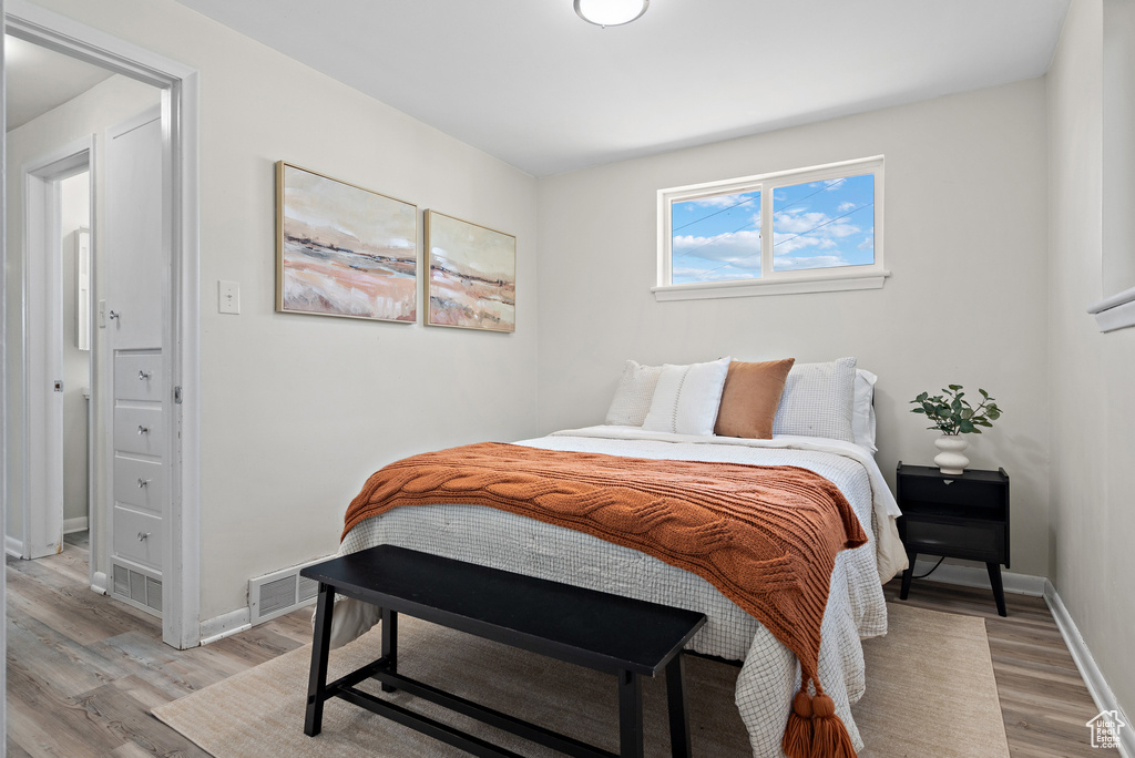 Bedroom featuring light wood finished floors and baseboards