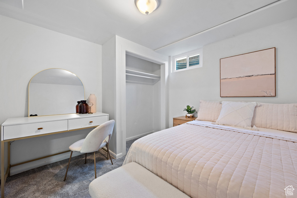 Carpeted bedroom featuring a closet and an office area