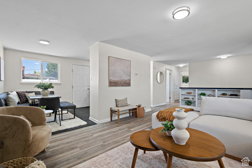 Living room with light wood-style floors and baseboards