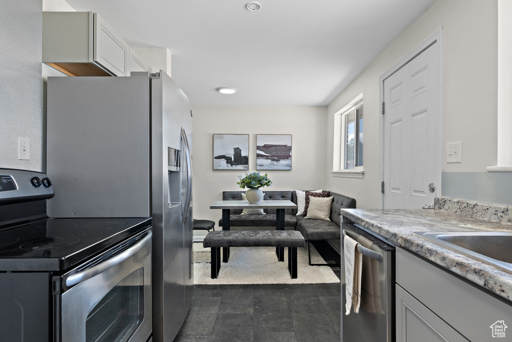 Kitchen featuring stainless steel appliances and light countertops