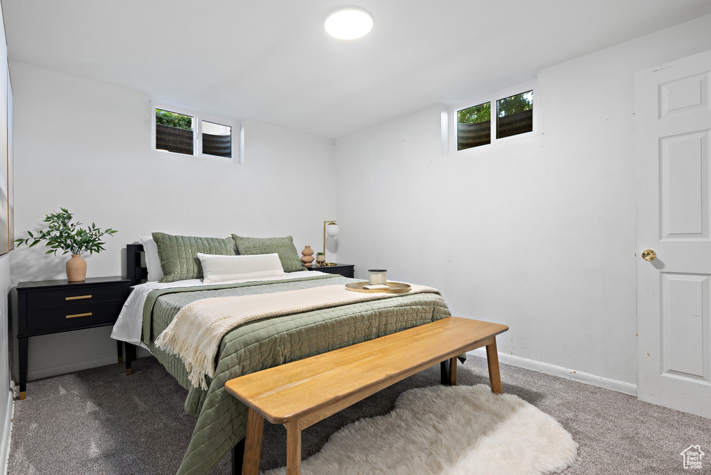 Bedroom featuring carpet and baseboards