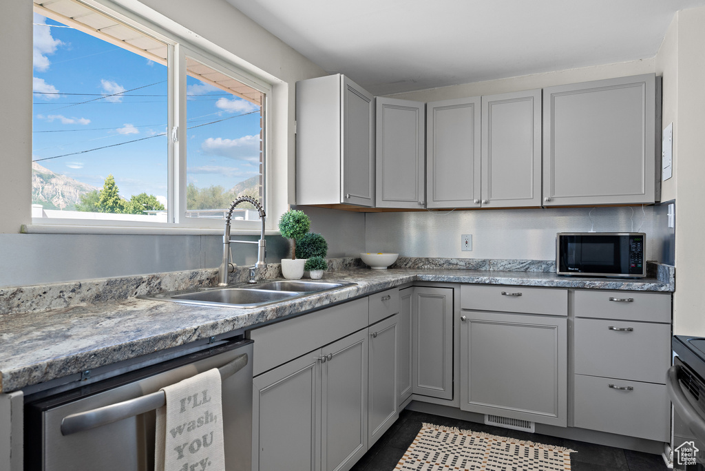 Kitchen featuring appliances with stainless steel finishes and light countertops