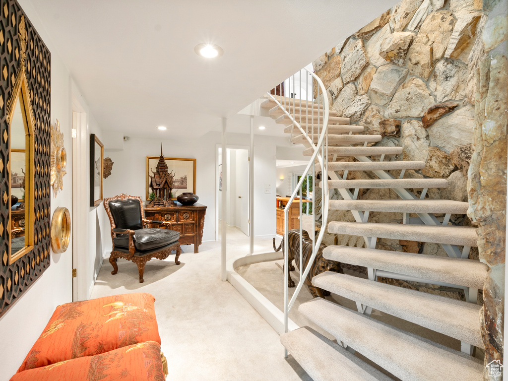 Stairs with carpet flooring and recessed lighting