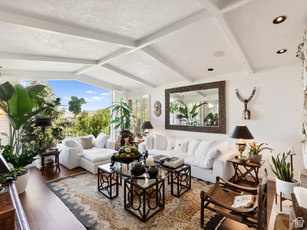 Living area with wood finished floors, recessed lighting, and a textured ceiling