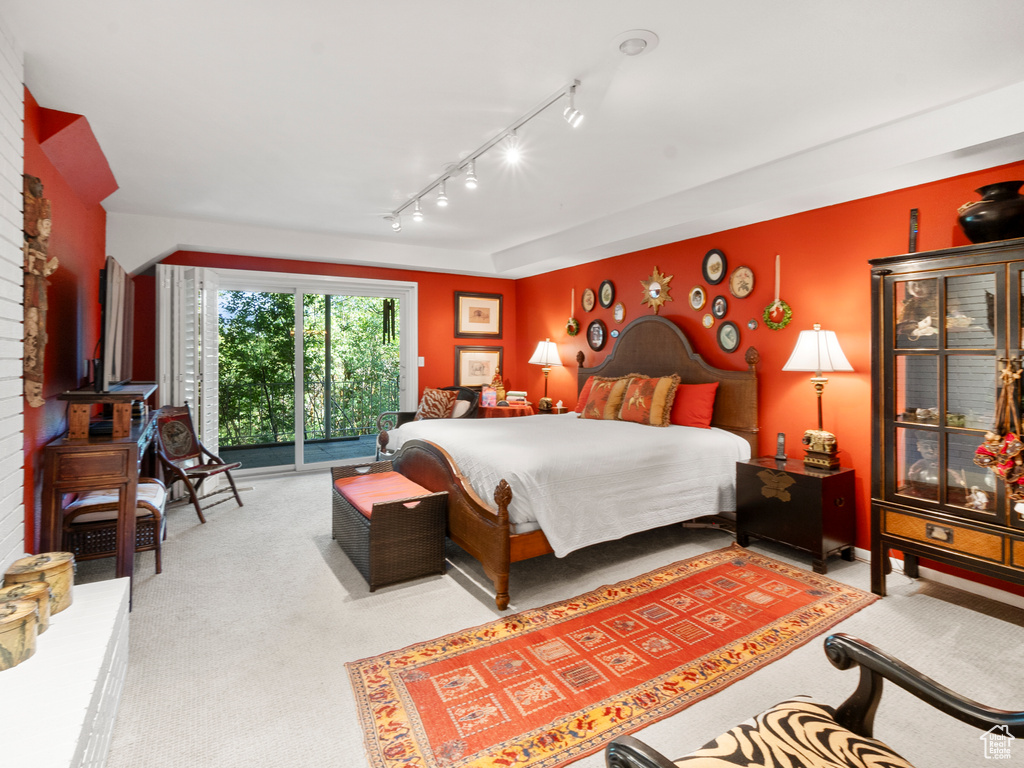 Carpeted bedroom with access to exterior and rail lighting