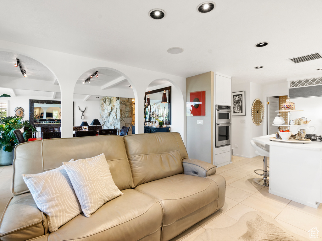 Living room featuring a ceiling fan, light tile patterned flooring, and recessed lighting