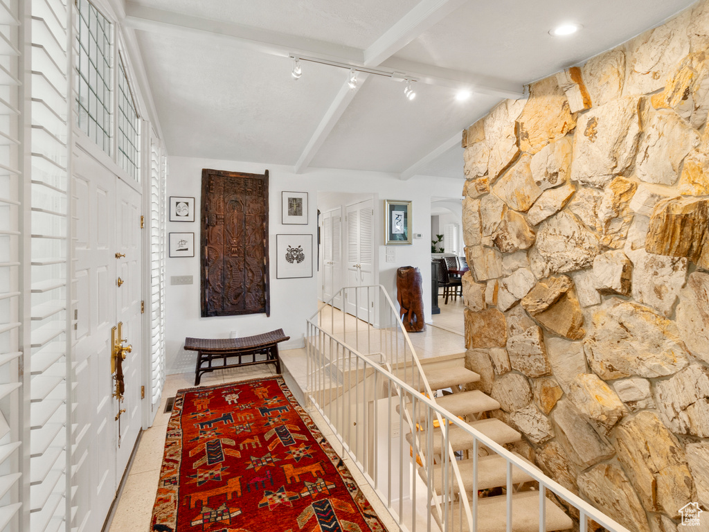 Hall featuring track lighting and an upstairs landing
