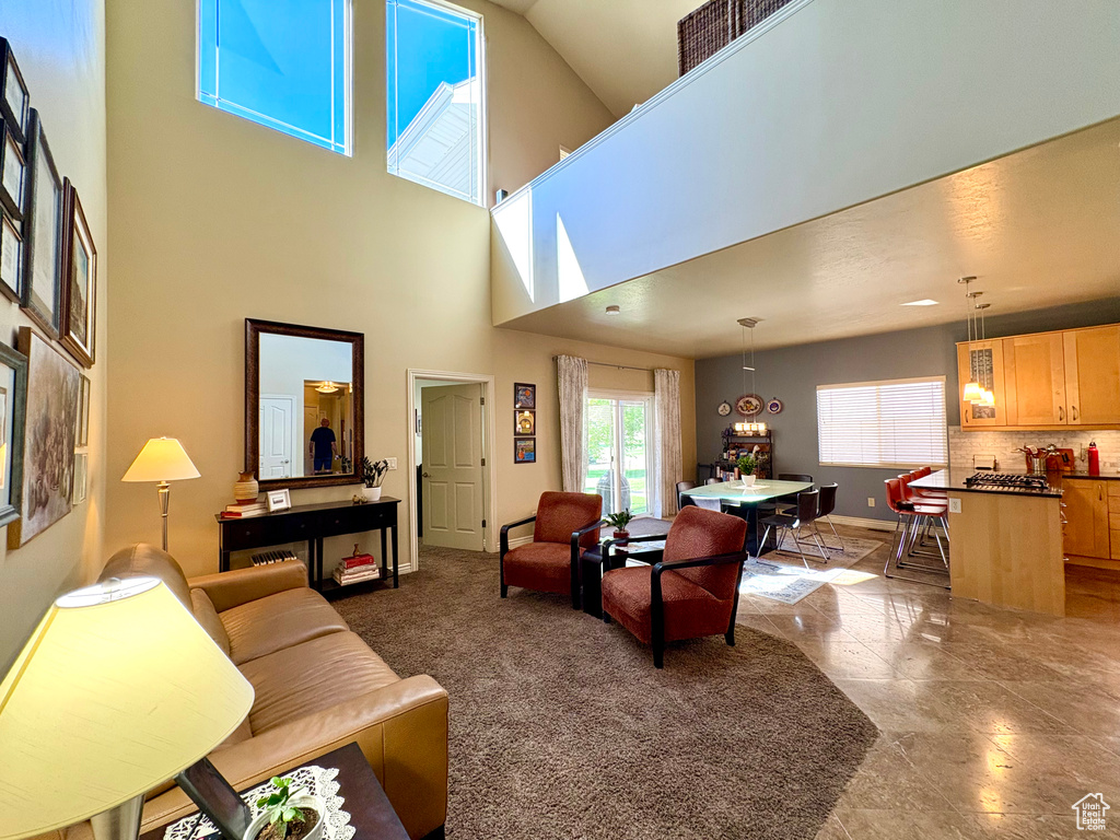 Living room featuring baseboards and a high ceiling