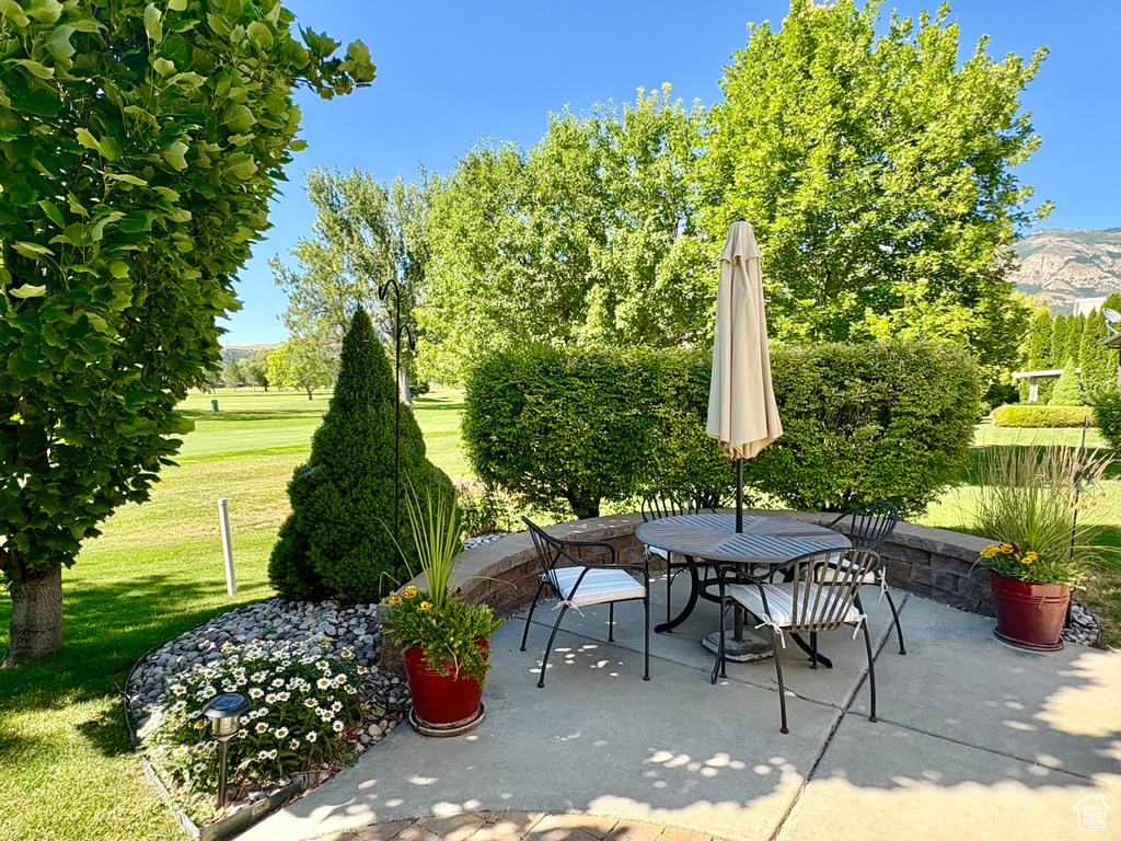 View of patio featuring outdoor dining area and a mountain view