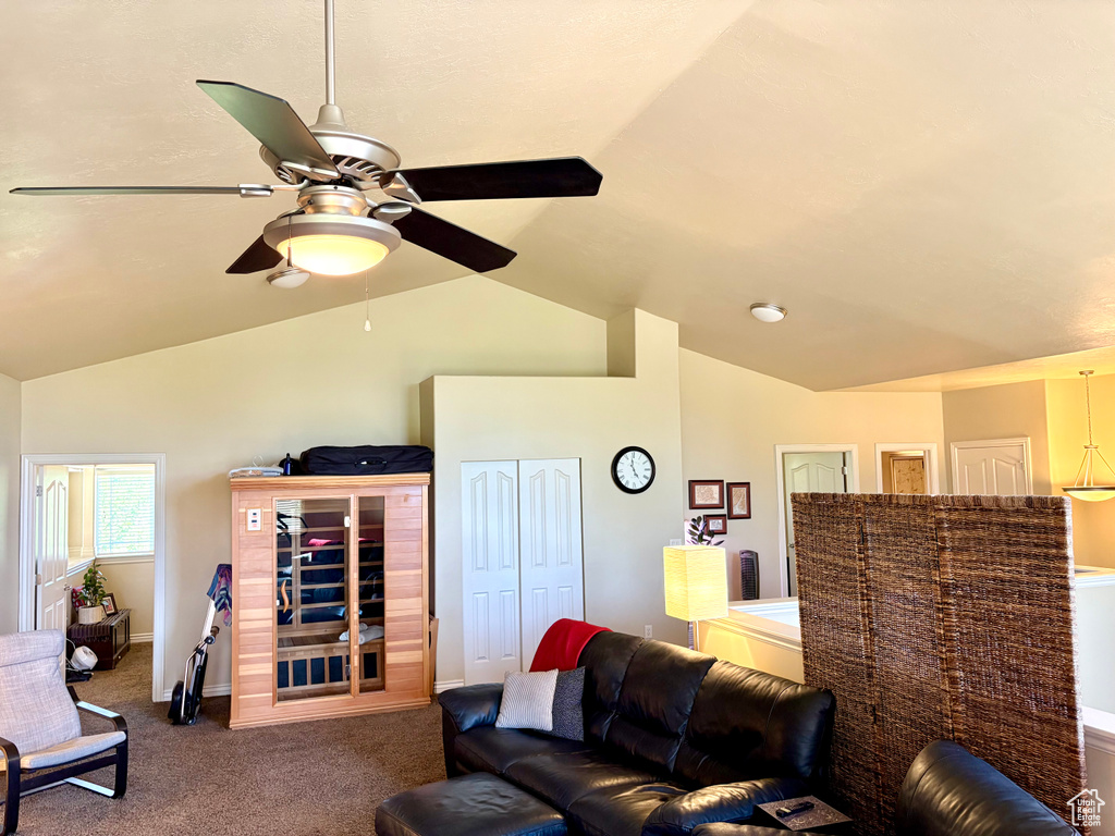 Living area with carpet, a ceiling fan, and high vaulted ceiling