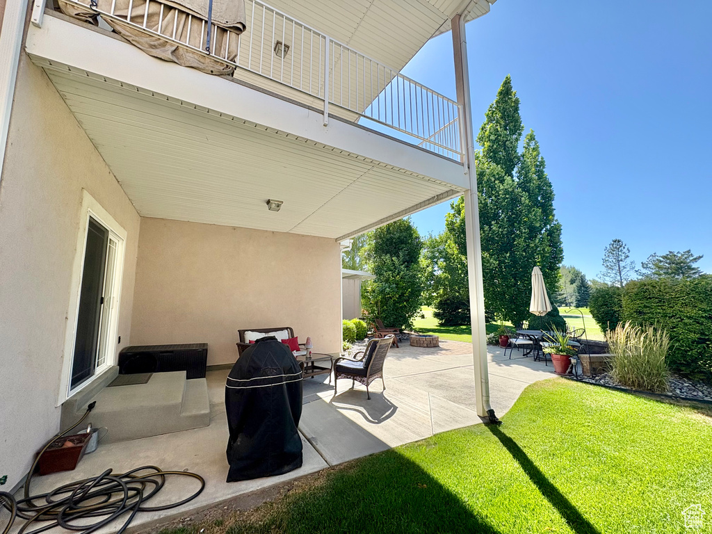 Patio / terrace featuring a patio area, a lawn, and an outdoor fire pit