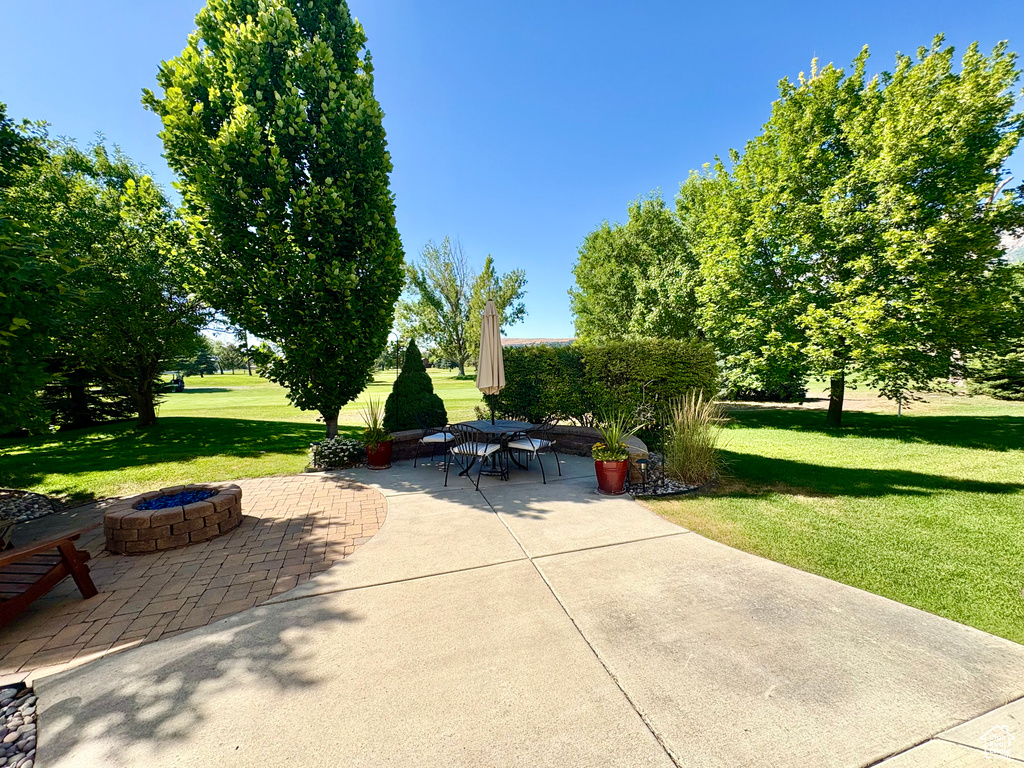 View of patio featuring an outdoor fire pit