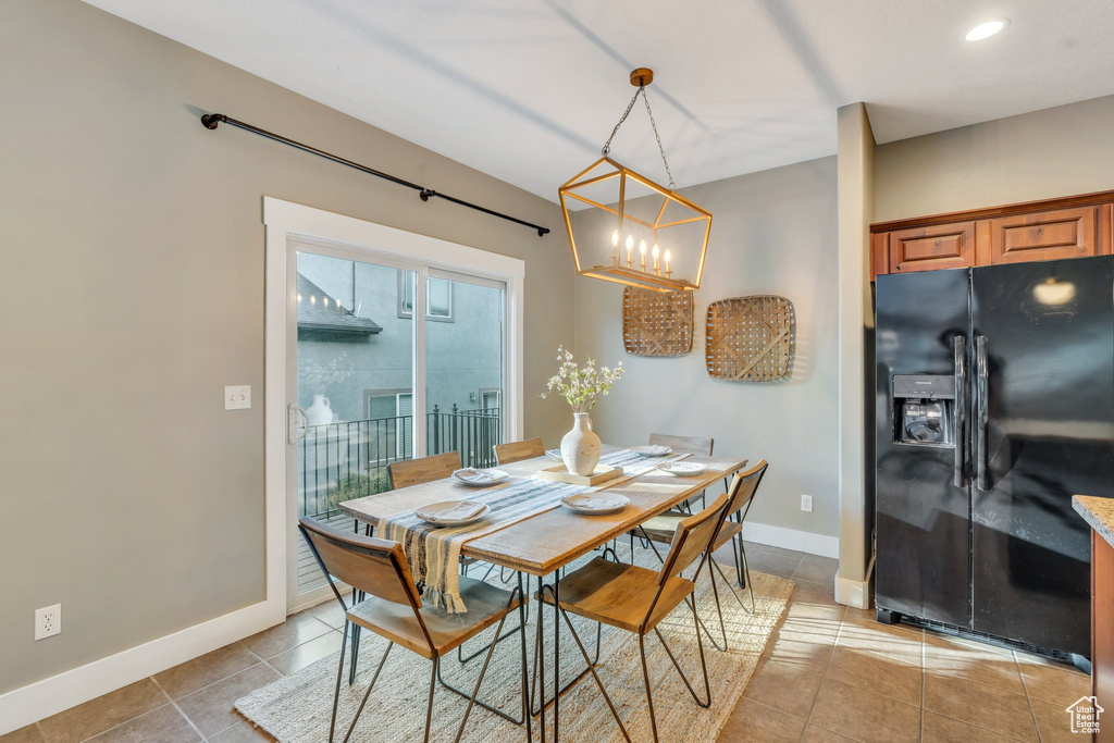 Dining area featuring a chandelier, light tile patterned floors, and recessed lighting