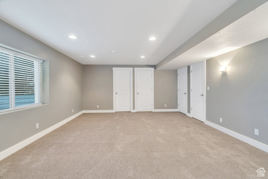 Unfurnished bedroom featuring recessed lighting and light carpet