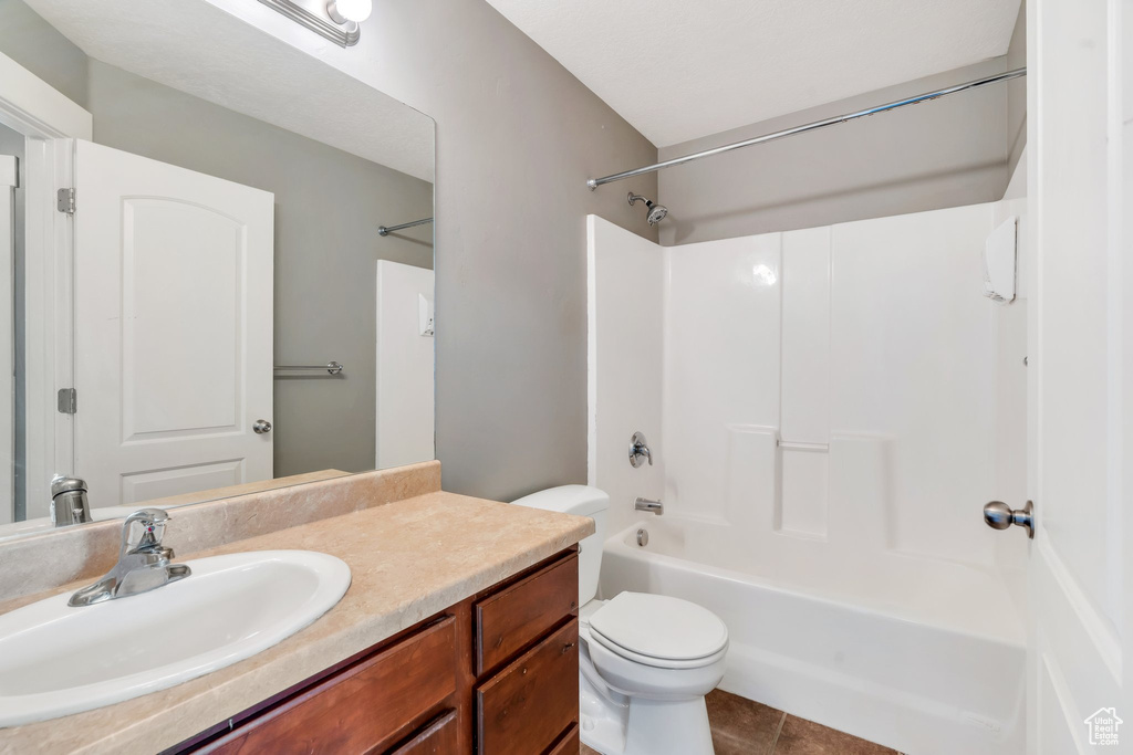 Bathroom featuring vanity, shower / tub combination, and tile patterned floors