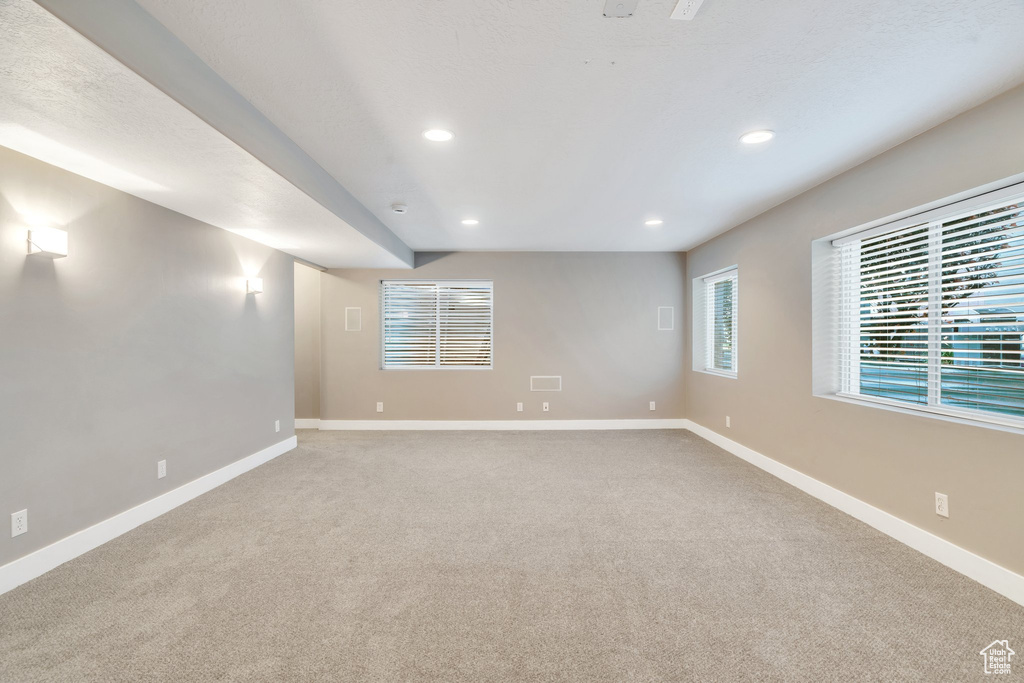 Empty room featuring recessed lighting and light carpet