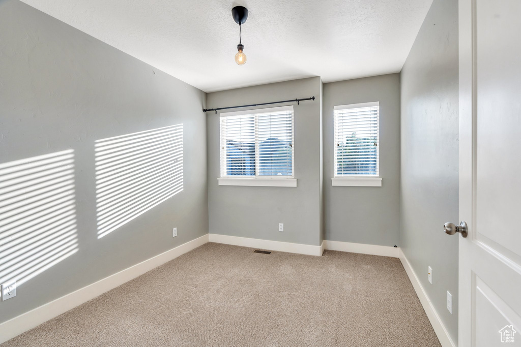 Spare room with carpet floors and baseboards