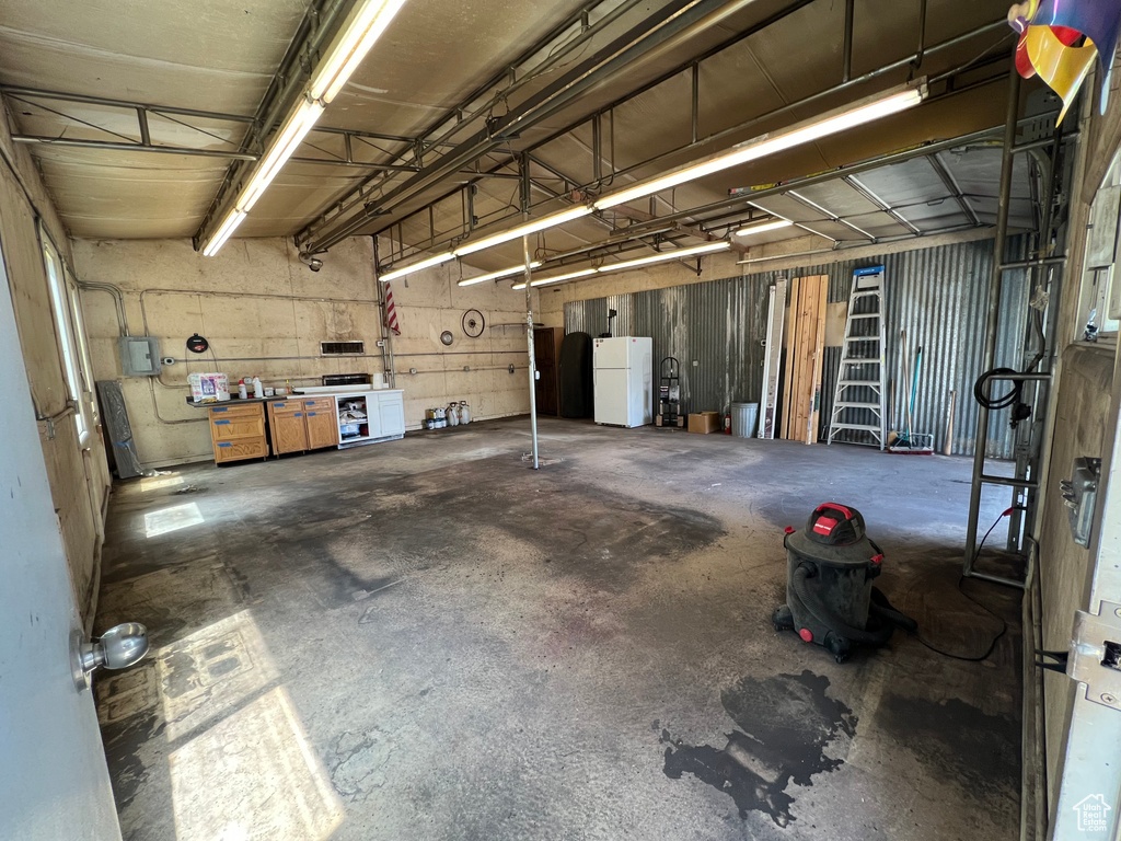 Garage featuring freestanding refrigerator
