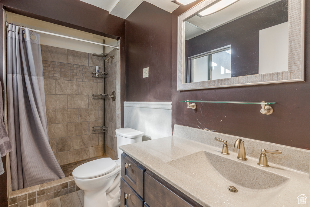 Full bathroom featuring vanity and tiled shower