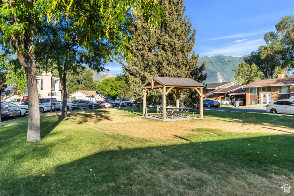 View of grassy yard with a gazebo and a mountain view