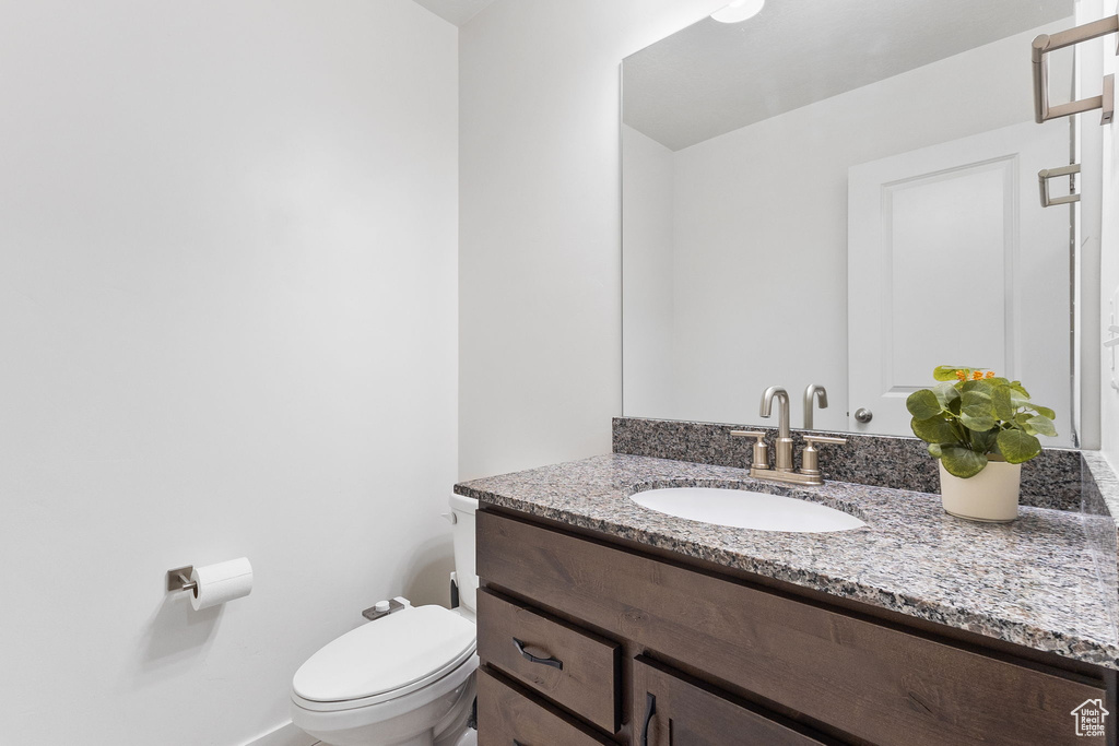 Bathroom featuring vanity and toilet