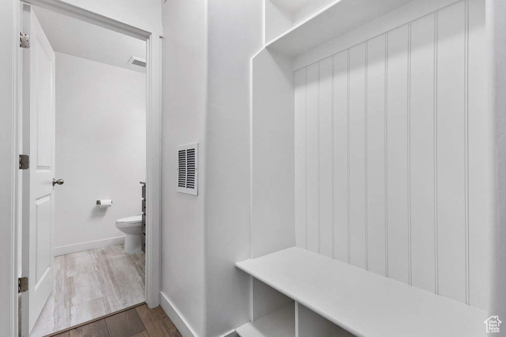 Mudroom with wood finished floors and baseboards