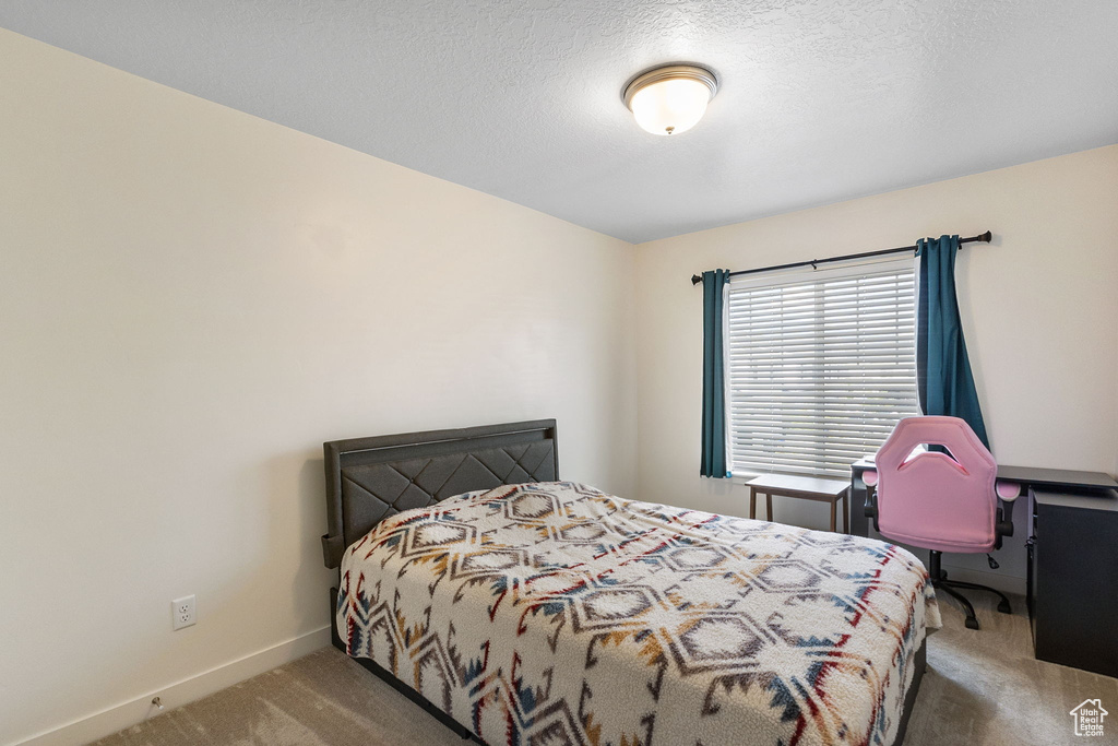 Carpeted bedroom with baseboards