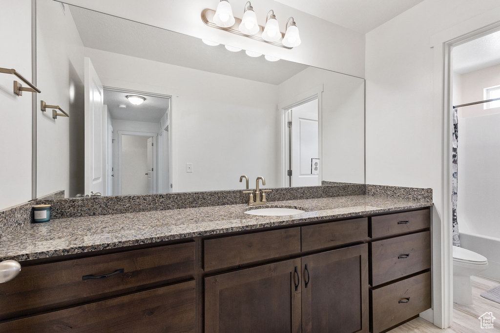 Full bath featuring vanity and shower / bath combo with shower curtain