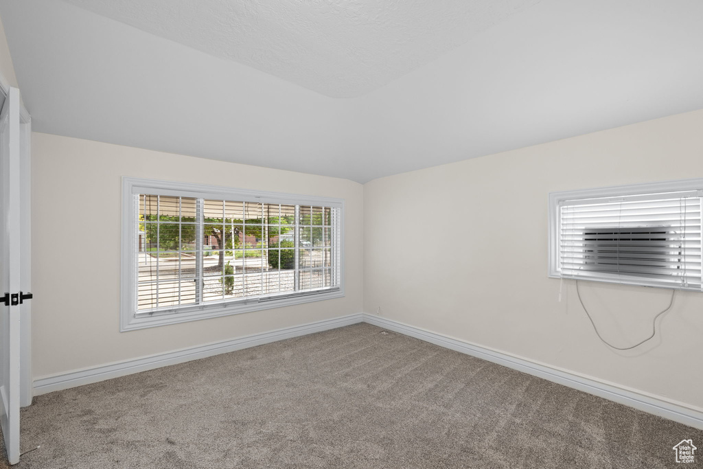 Carpeted empty room featuring baseboards