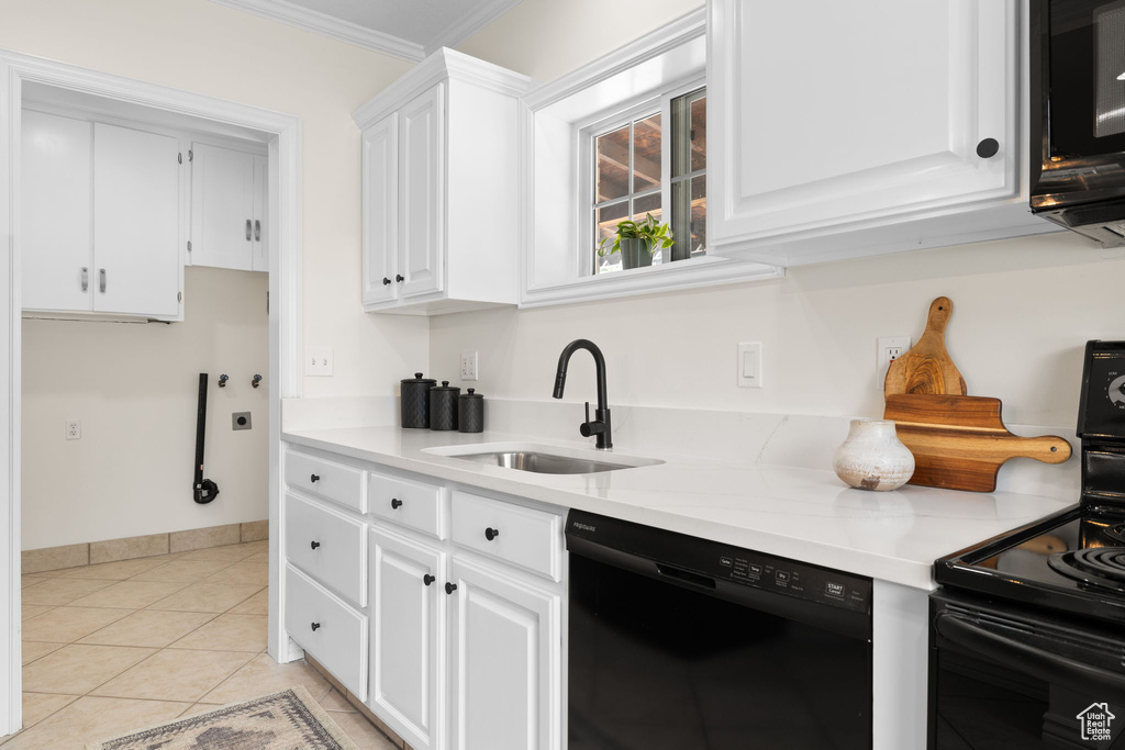 Kitchen featuring black appliances, white cabinets, light countertops, ornamental molding, and light tile patterned flooring