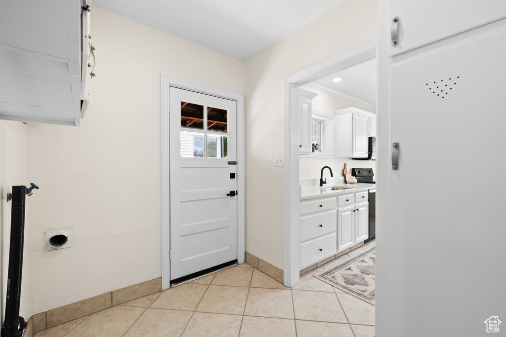 Interior space with baseboards and light tile patterned flooring