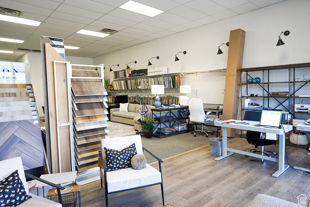 Office space with wood finished floors and a paneled ceiling