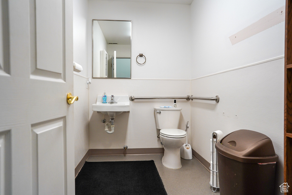 Bathroom with toilet and baseboards