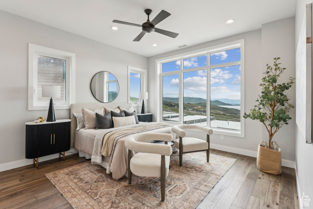 Bedroom featuring a mountain view, wood finished floors, recessed lighting, and ceiling fan