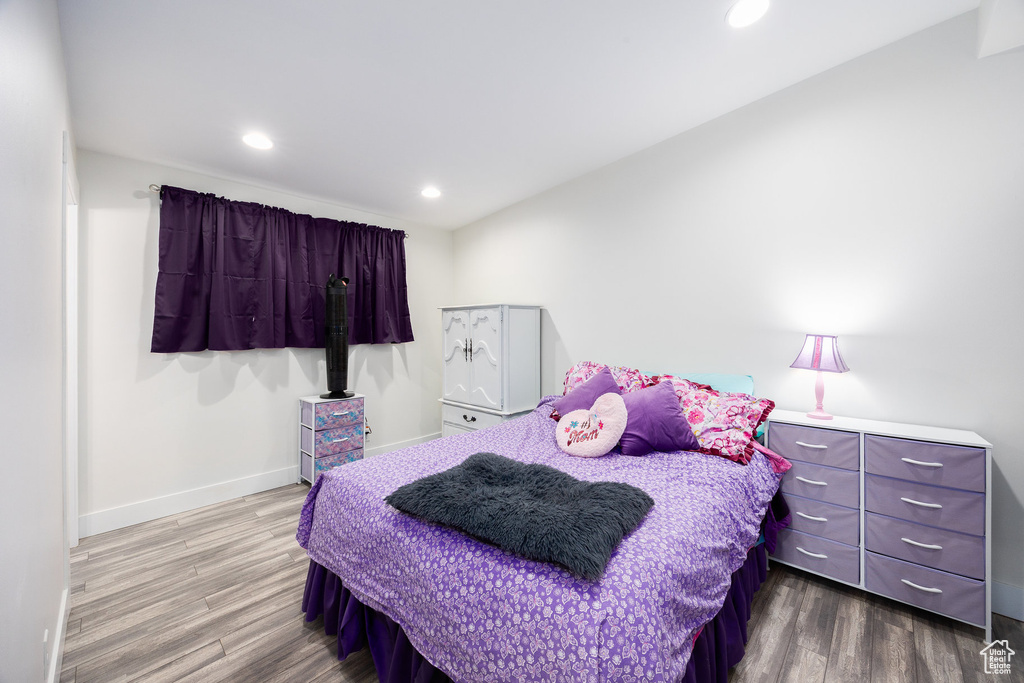 Bedroom with wood finished floors and recessed lighting