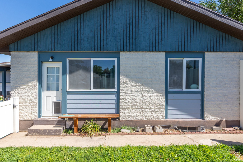View of property exterior featuring brick siding and entry steps