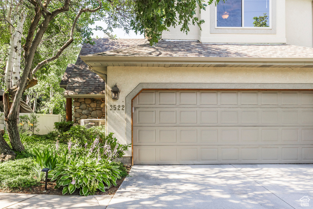Garage featuring concrete driveway