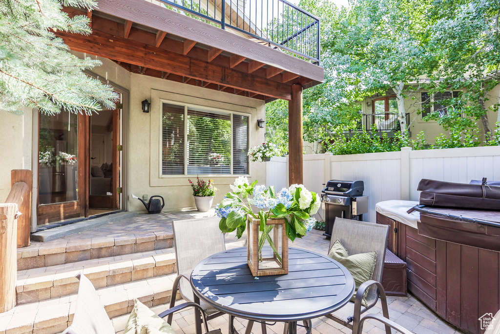 Patio / terrace featuring a hot tub, a patio, a grill, and outdoor dining area