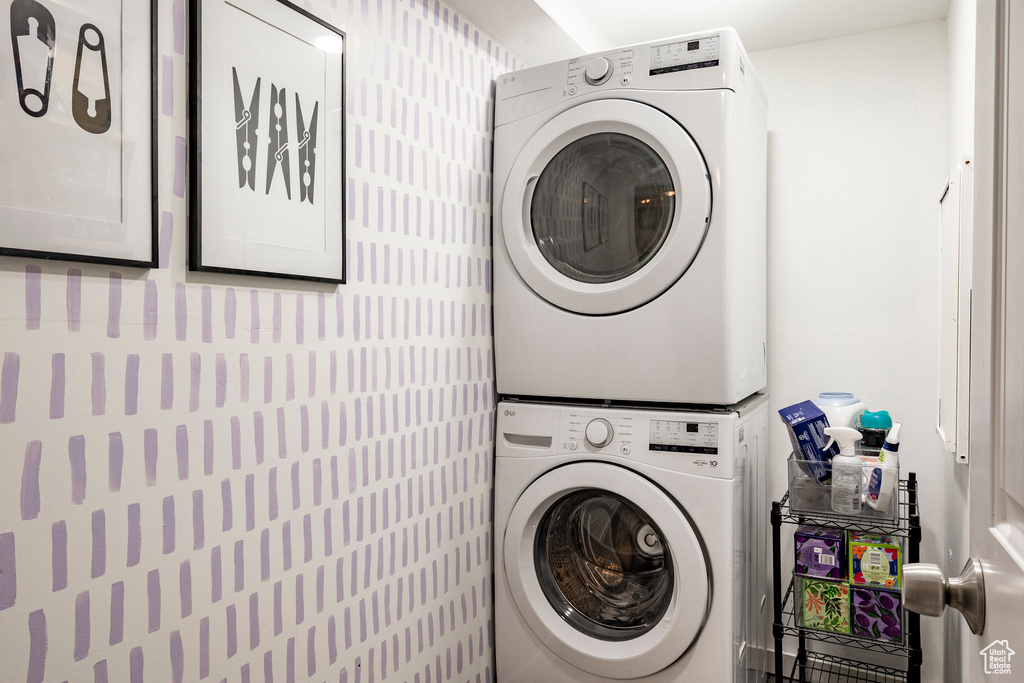 Washroom featuring stacked washing machine and dryer