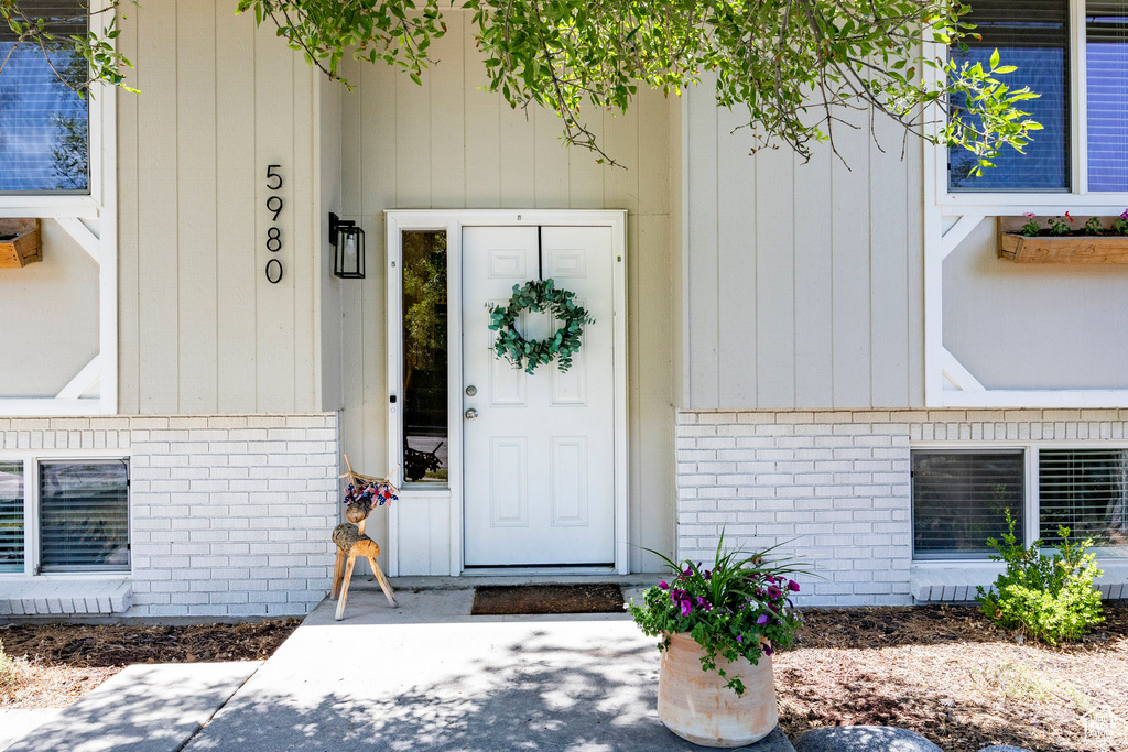 View of exterior entry featuring brick siding