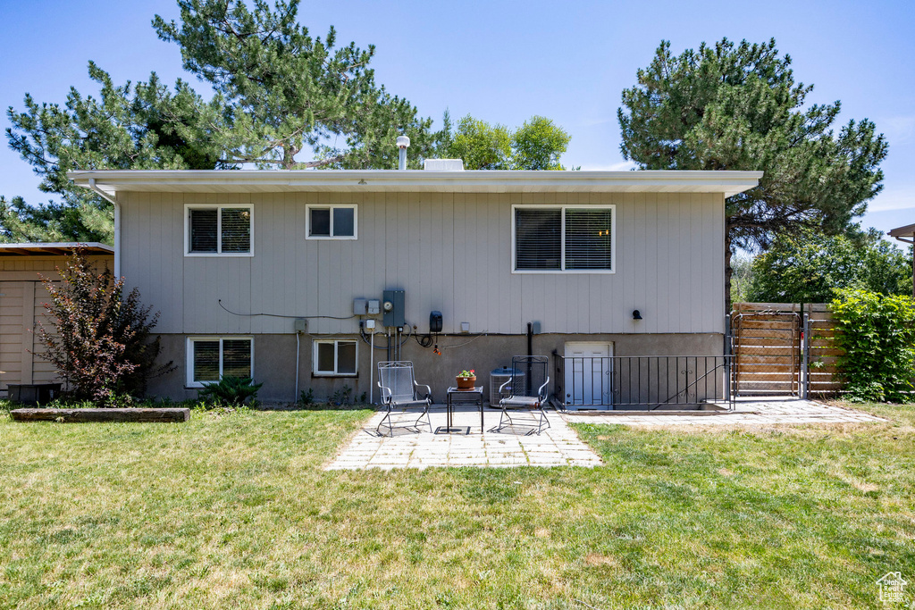 Back of property with a patio and a gate
