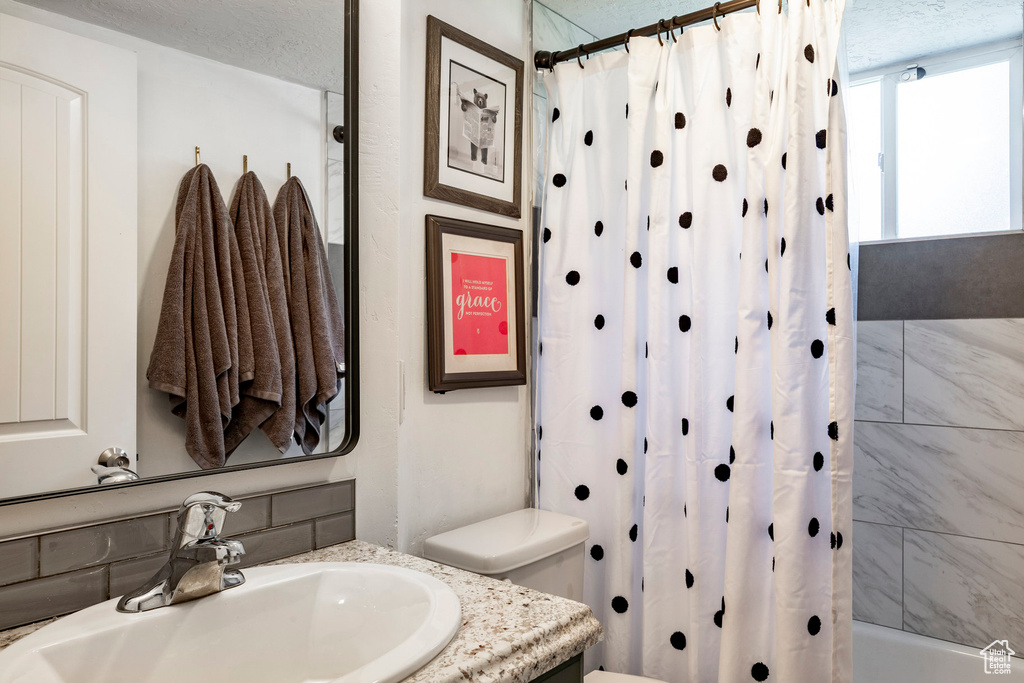 Bathroom with vanity and shower / bath combination with curtain