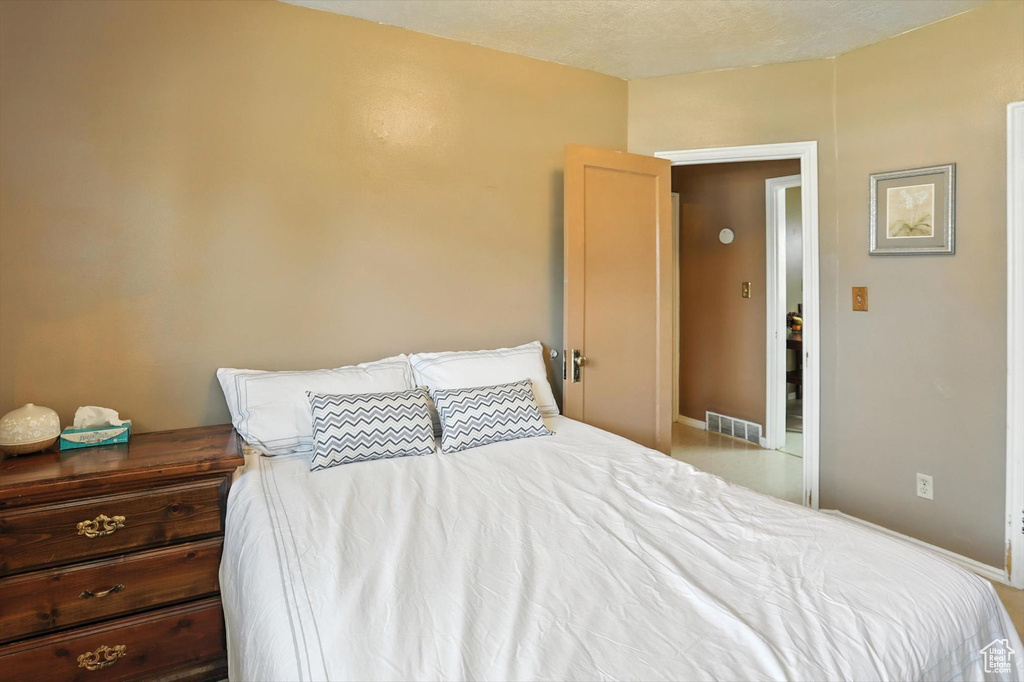 Bedroom with a textured ceiling