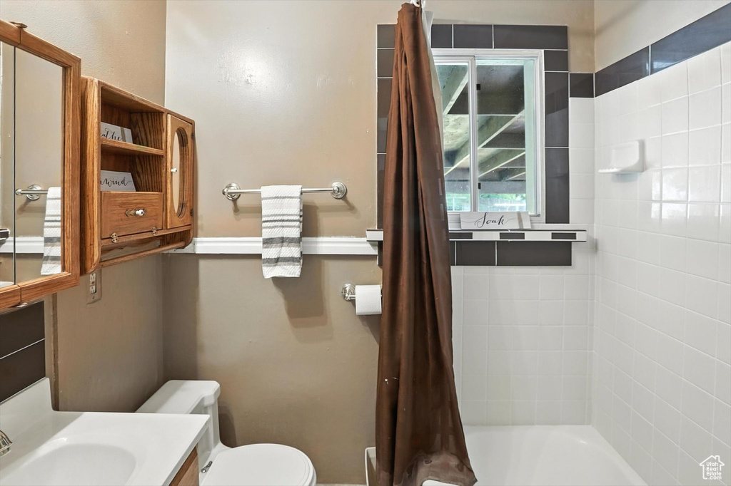 Full bath featuring vanity and shower / bath combo